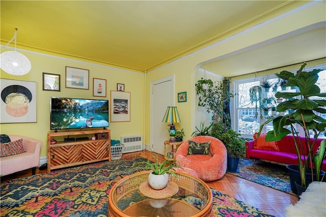 living room with crown molding, arched walkways, and visible vents