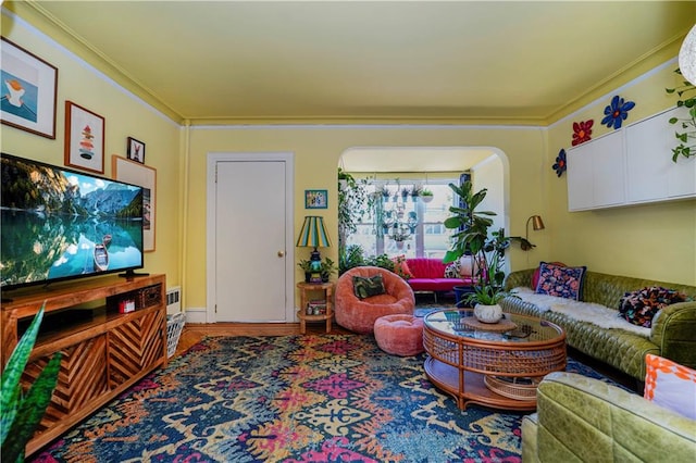 living room featuring arched walkways and ornamental molding