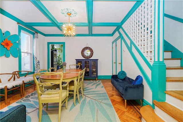 dining area with baseboards, beamed ceiling, stairs, an inviting chandelier, and coffered ceiling