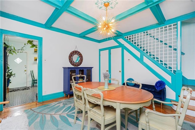 dining area with a notable chandelier, coffered ceiling, stairway, and wood finished floors