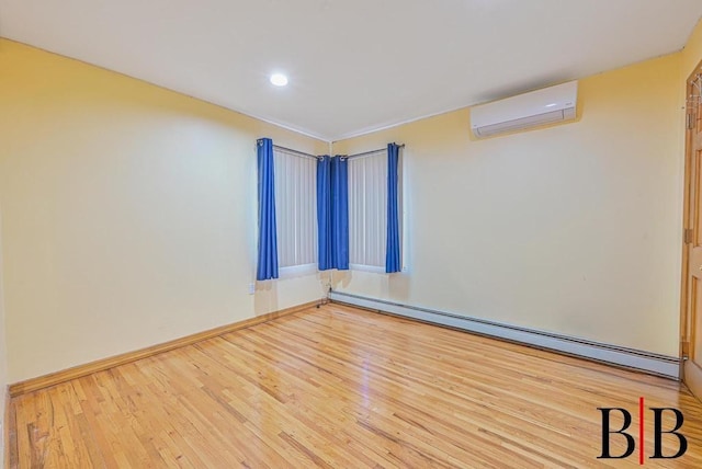 empty room with baseboards, baseboard heating, hardwood / wood-style floors, and a wall unit AC