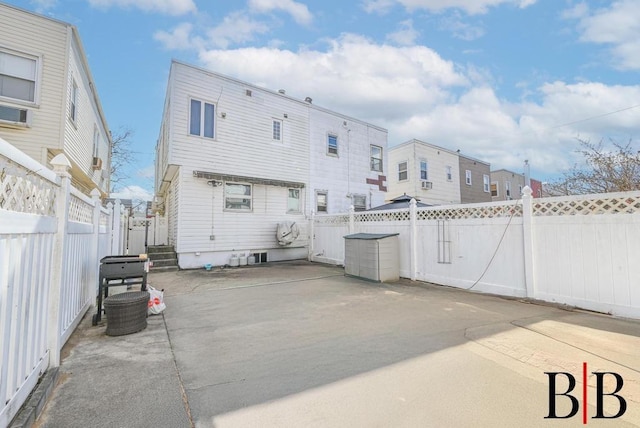 back of house with a patio and a fenced backyard