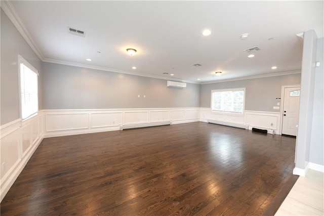 spare room featuring a wall mounted air conditioner, visible vents, dark wood finished floors, and recessed lighting