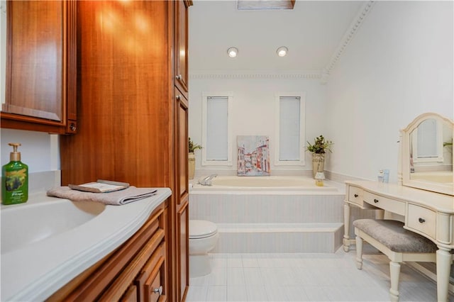 bathroom featuring toilet, a bath, and vanity