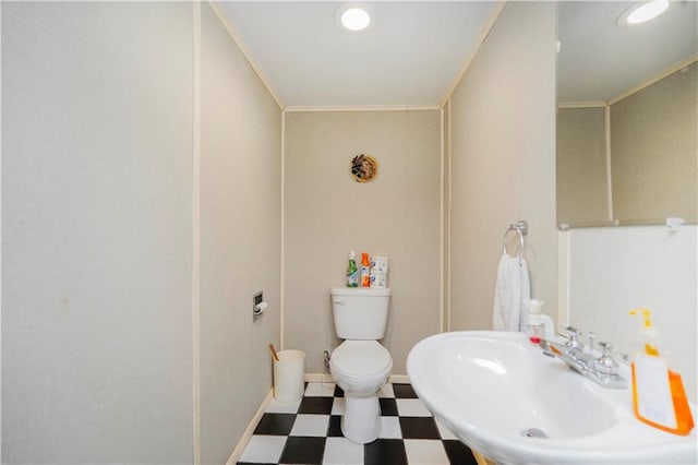 bathroom with a sink, tile patterned floors, toilet, and ornamental molding