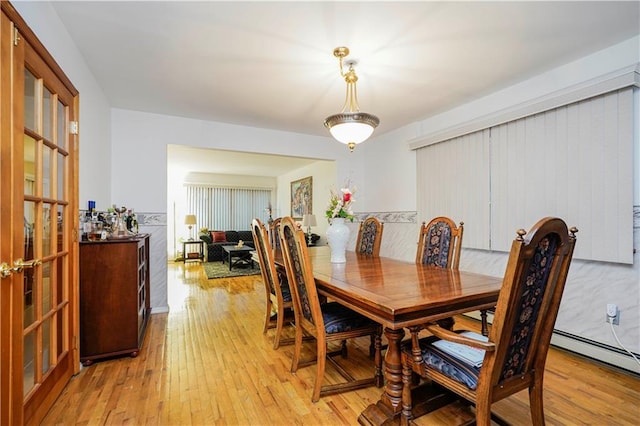 dining space featuring light wood-style flooring