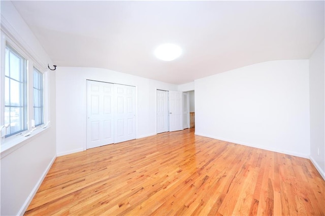 spare room featuring baseboards and light wood-type flooring