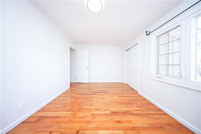 spare room featuring light wood-style flooring and baseboards