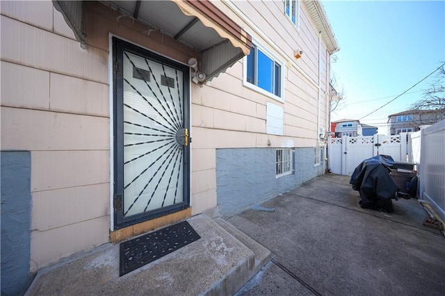 view of side of home featuring fence