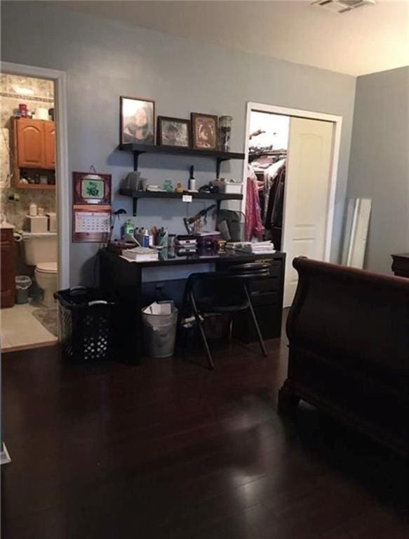 home office featuring dark wood-style flooring and visible vents