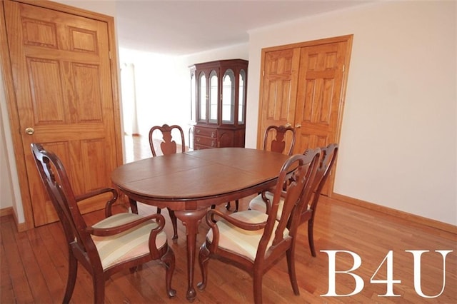 dining room featuring light wood-style floors and baseboards