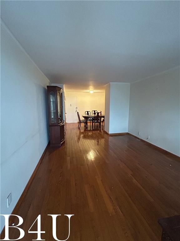 interior space with baseboards and wood finished floors