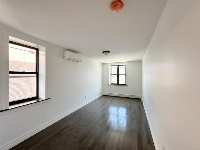 spare room featuring a baseboard heating unit, a wall mounted AC, baseboards, and dark wood-style flooring