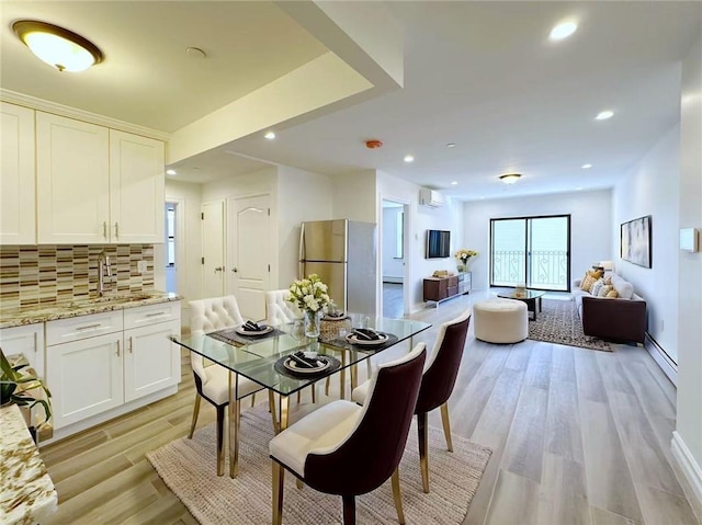 dining area with recessed lighting, a wall mounted AC, light wood-style floors, and a baseboard radiator