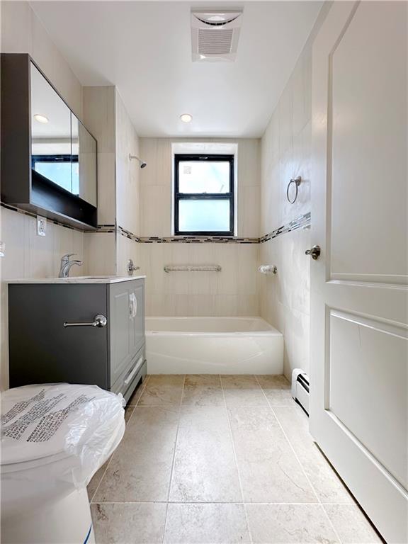 bathroom with vanity, visible vents, a baseboard radiator, tub / shower combination, and toilet