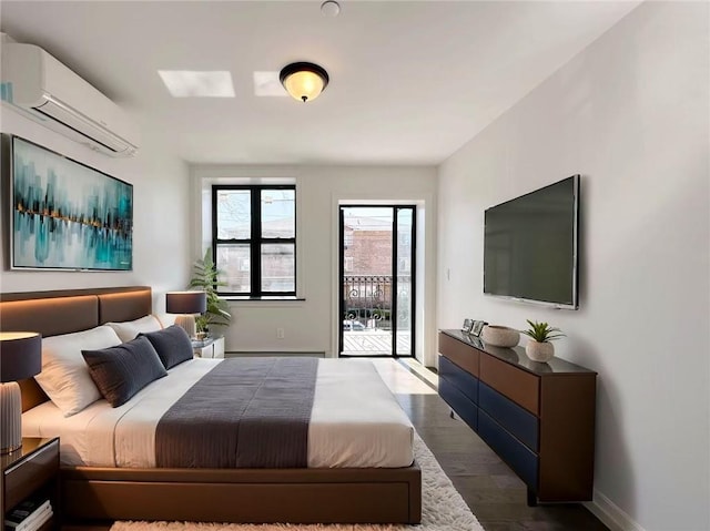 bedroom featuring baseboards, dark wood-type flooring, access to exterior, and a wall mounted AC