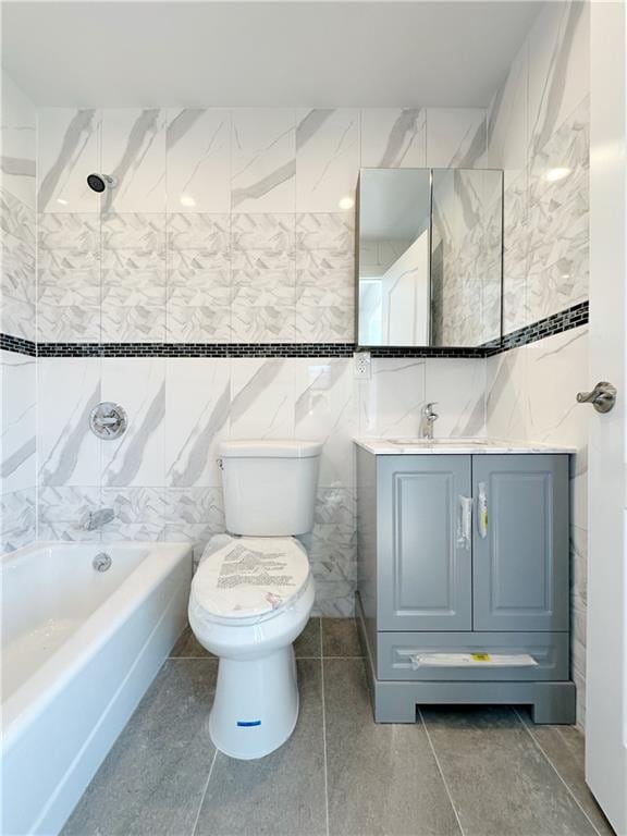 full bathroom featuring tile patterned flooring, shower / washtub combination, toilet, vanity, and tile walls