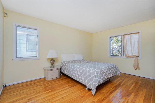 bedroom with baseboards and light wood-style floors