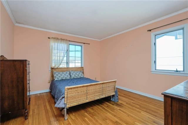 bedroom featuring light wood-type flooring, baseboards, and ornamental molding