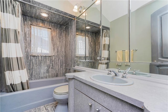 bathroom with lofted ceiling, toilet, shower / bath combo, and vanity