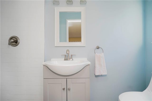 bathroom featuring toilet and vanity