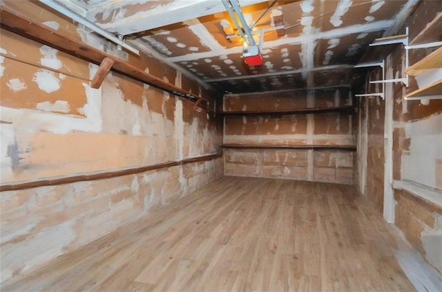 basement with wood finished floors and a garage