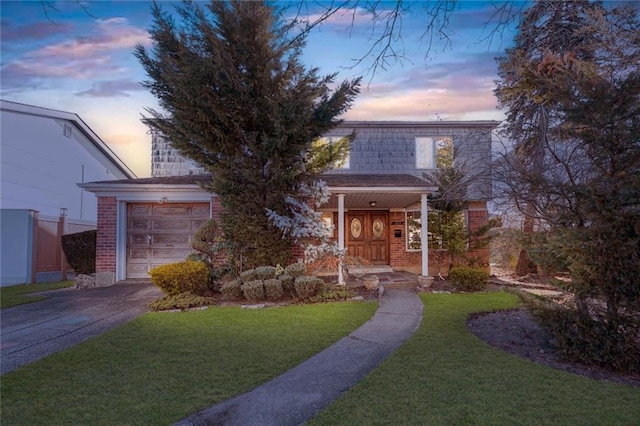 view of front facade with a lawn, driveway, mansard roof, an attached garage, and brick siding