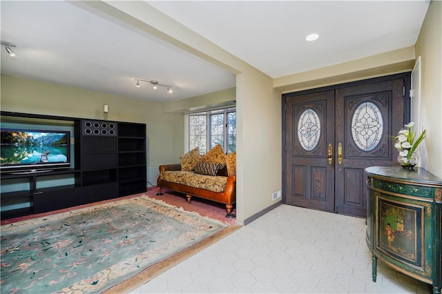 foyer featuring baseboards