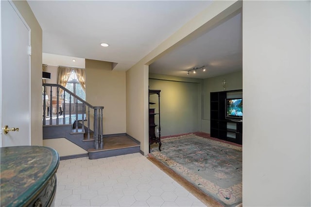 entrance foyer with recessed lighting, baseboards, track lighting, and stairs