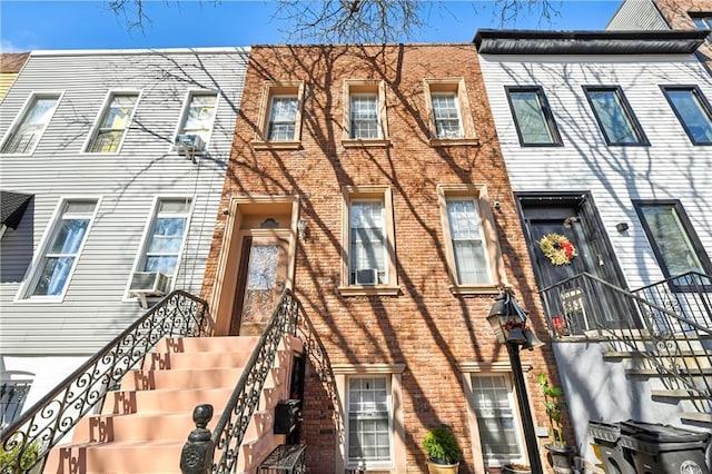 townhome / multi-family property featuring brick siding