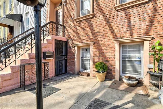 property entrance featuring brick siding