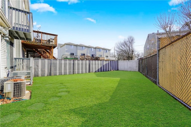 view of yard featuring a deck, cooling unit, stairs, and a fenced backyard