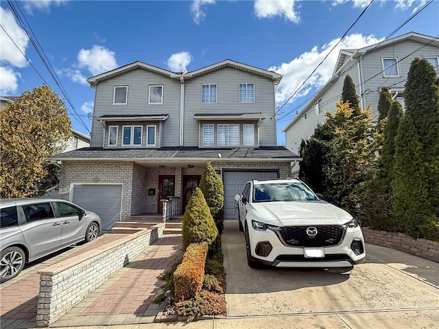 view of front of home featuring brick siding, driveway, and an attached garage