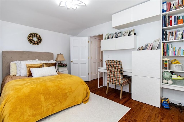 bedroom with lofted ceiling and dark wood-style floors