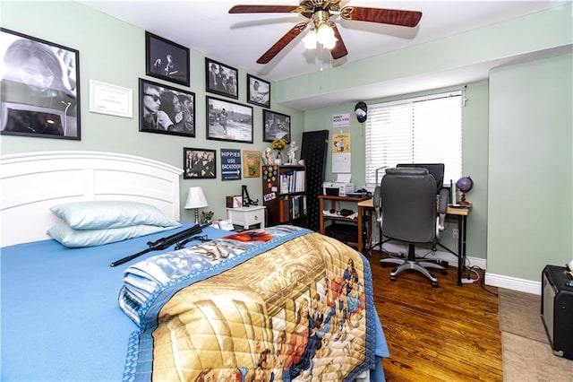 bedroom with a ceiling fan, baseboards, and wood finished floors