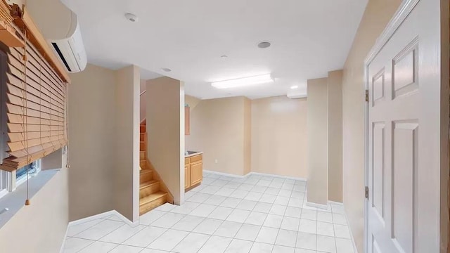 below grade area with stairway, light tile patterned floors, baseboards, and a wall mounted air conditioner