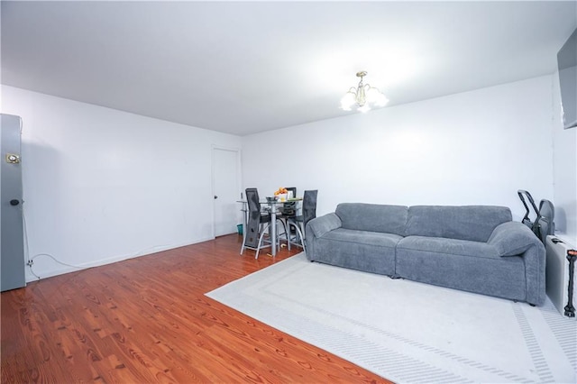 living room with a chandelier and wood finished floors