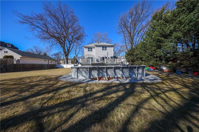 view of yard with an outdoor pool and fence