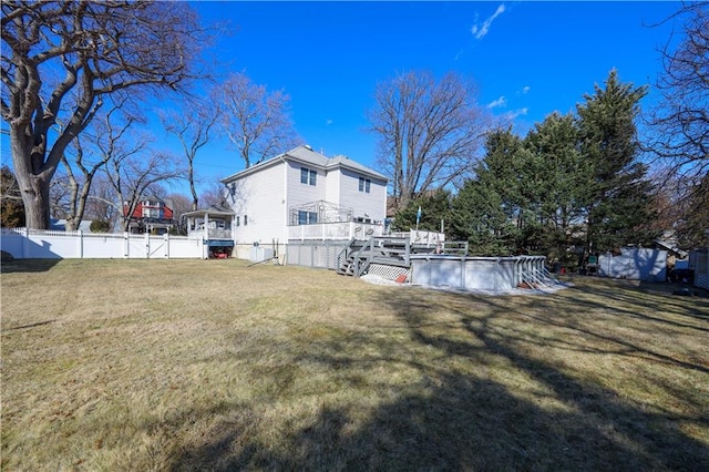 view of yard with a deck, a fenced in pool, and a fenced backyard