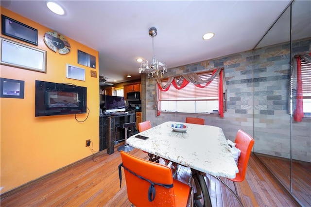dining space featuring an inviting chandelier, recessed lighting, and light wood finished floors