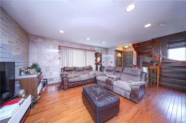 living area with visible vents, recessed lighting, stairs, and wood-type flooring