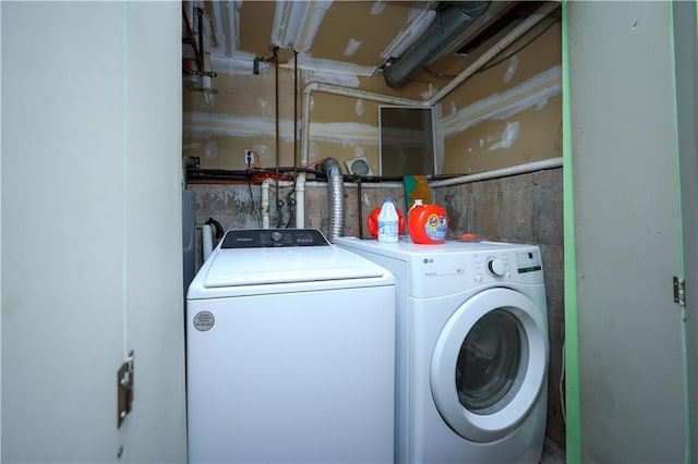 clothes washing area with separate washer and dryer and laundry area