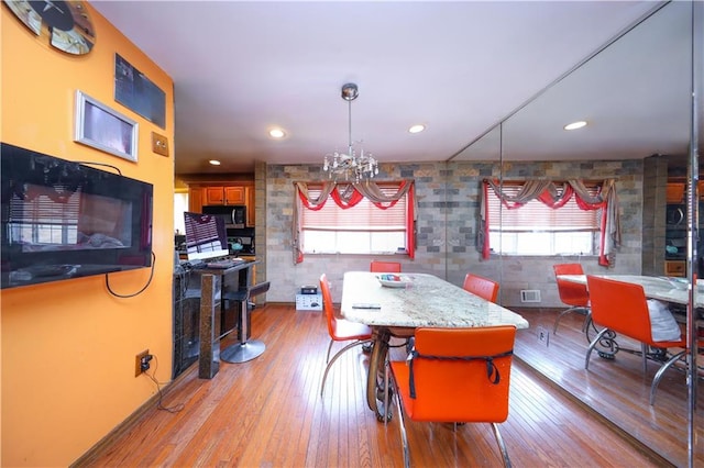 dining space featuring visible vents, hardwood / wood-style floors, a notable chandelier, and recessed lighting
