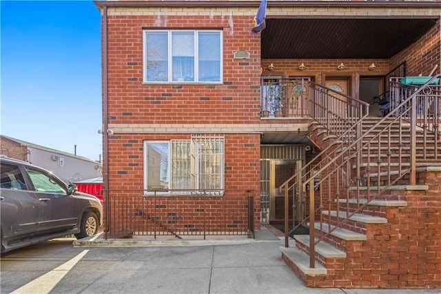 exterior space with stairway and brick siding