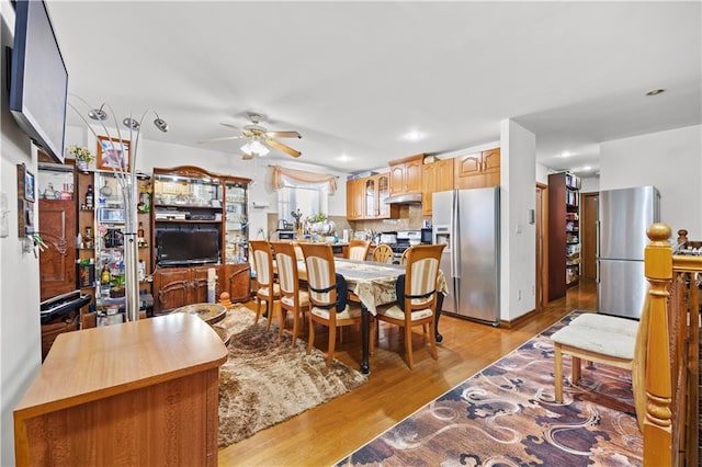 dining room with light wood-type flooring and ceiling fan