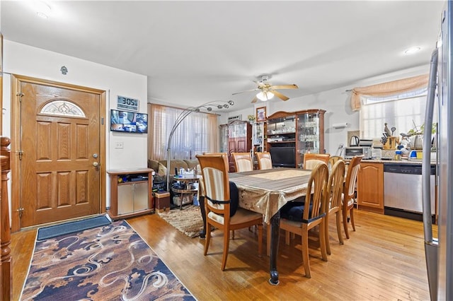 dining area featuring light wood-style flooring and a ceiling fan