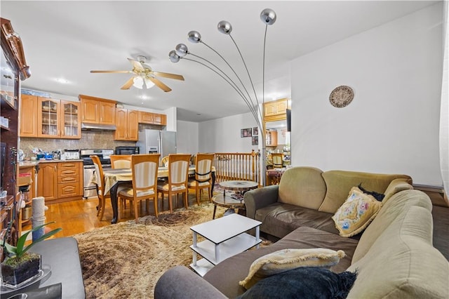 living room featuring light wood finished floors and ceiling fan