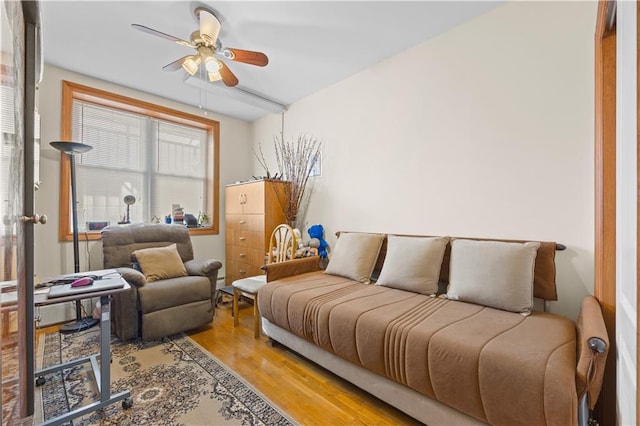 living room featuring wood finished floors and a ceiling fan