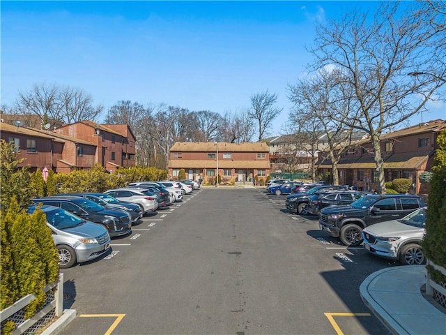 uncovered parking lot featuring a residential view