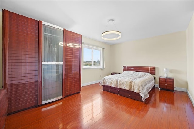 bedroom featuring baseboards and wood finished floors